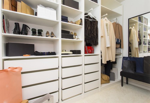 Modern walk in closet with luxury shoes and bags